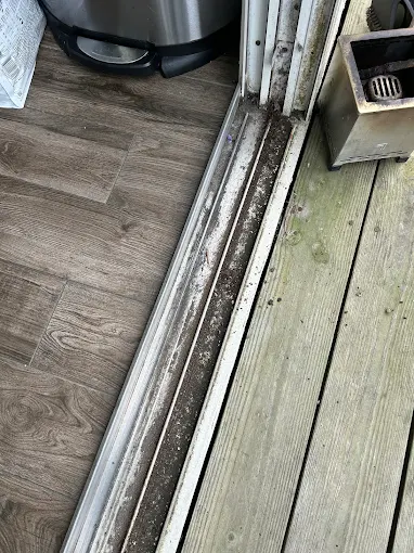 Torn screen door mesh before repair