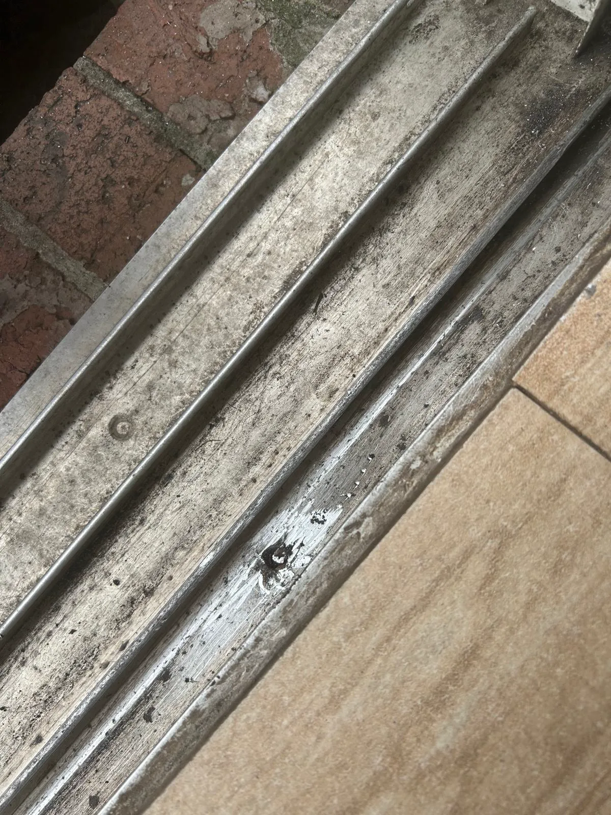 Worn sliding door track close up
